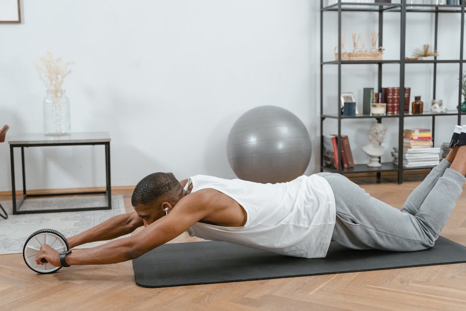 Man using an ab roller on a yoga mat indoors, promoting fitness and healthy lifestyle.